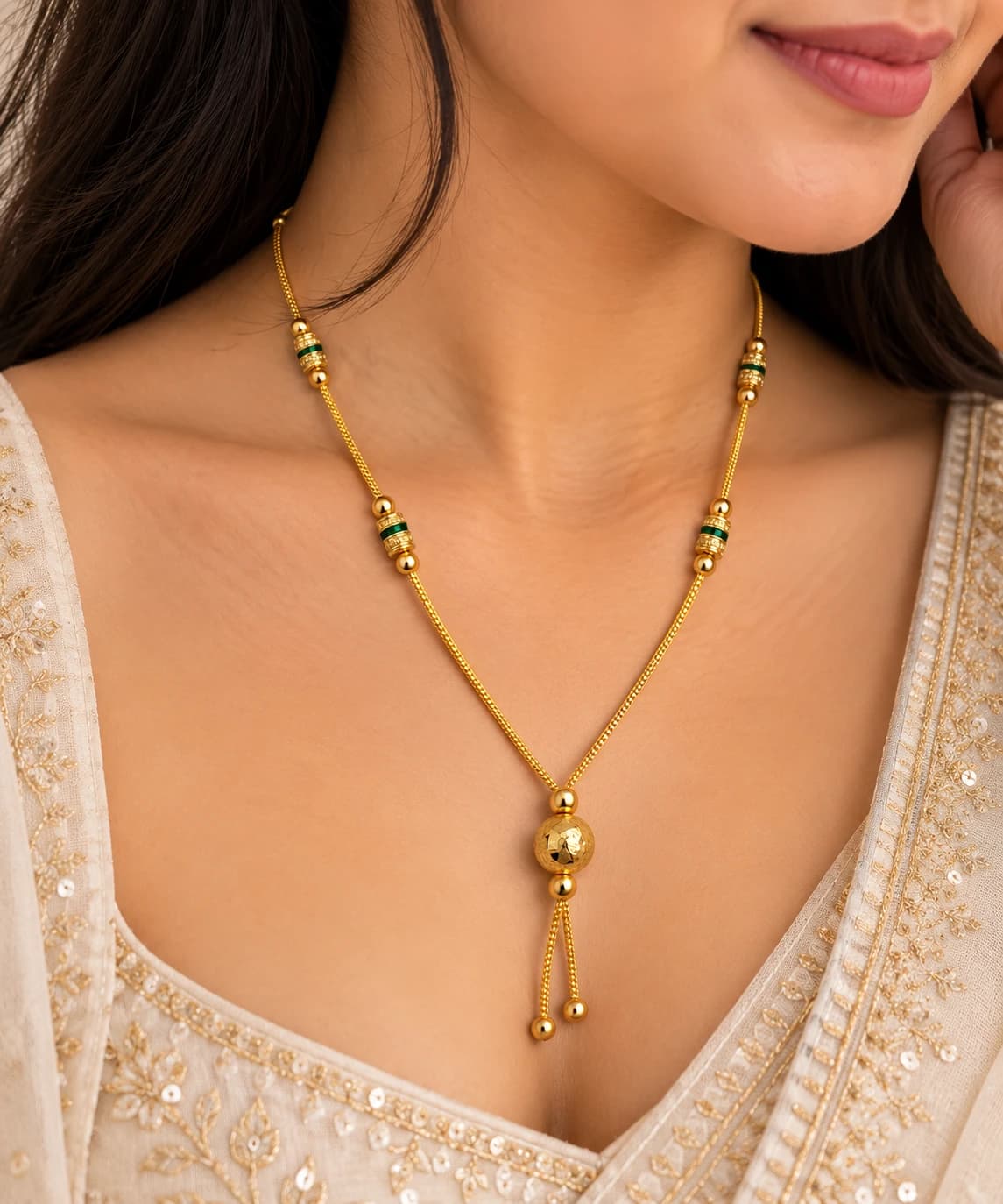 Aarohi green bead mangalsutra worn with an ivory embroidered outfit