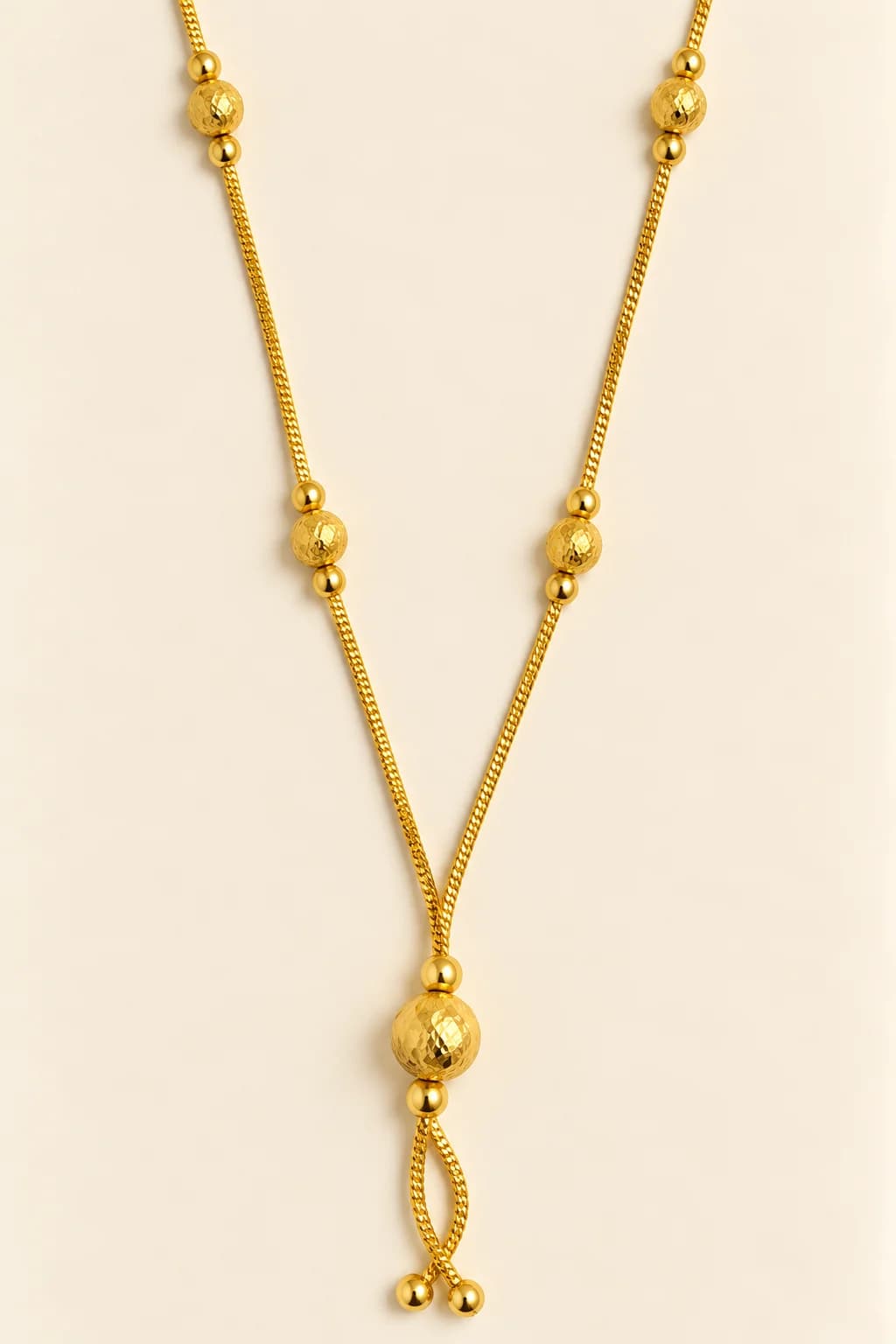 Anaya gold-tone mangalsutra with diamond-cut gold beads and a looped lariat gold drop