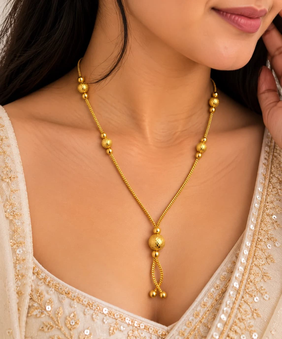 Anaya gold drop mangalsutra worn with an ivory embroidered outfit