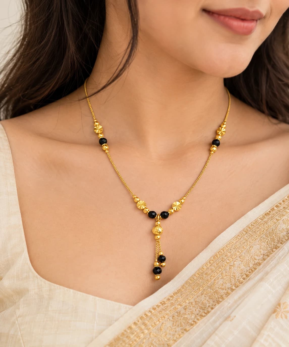 Riya black bead mangalsutra worn with an ivory saree