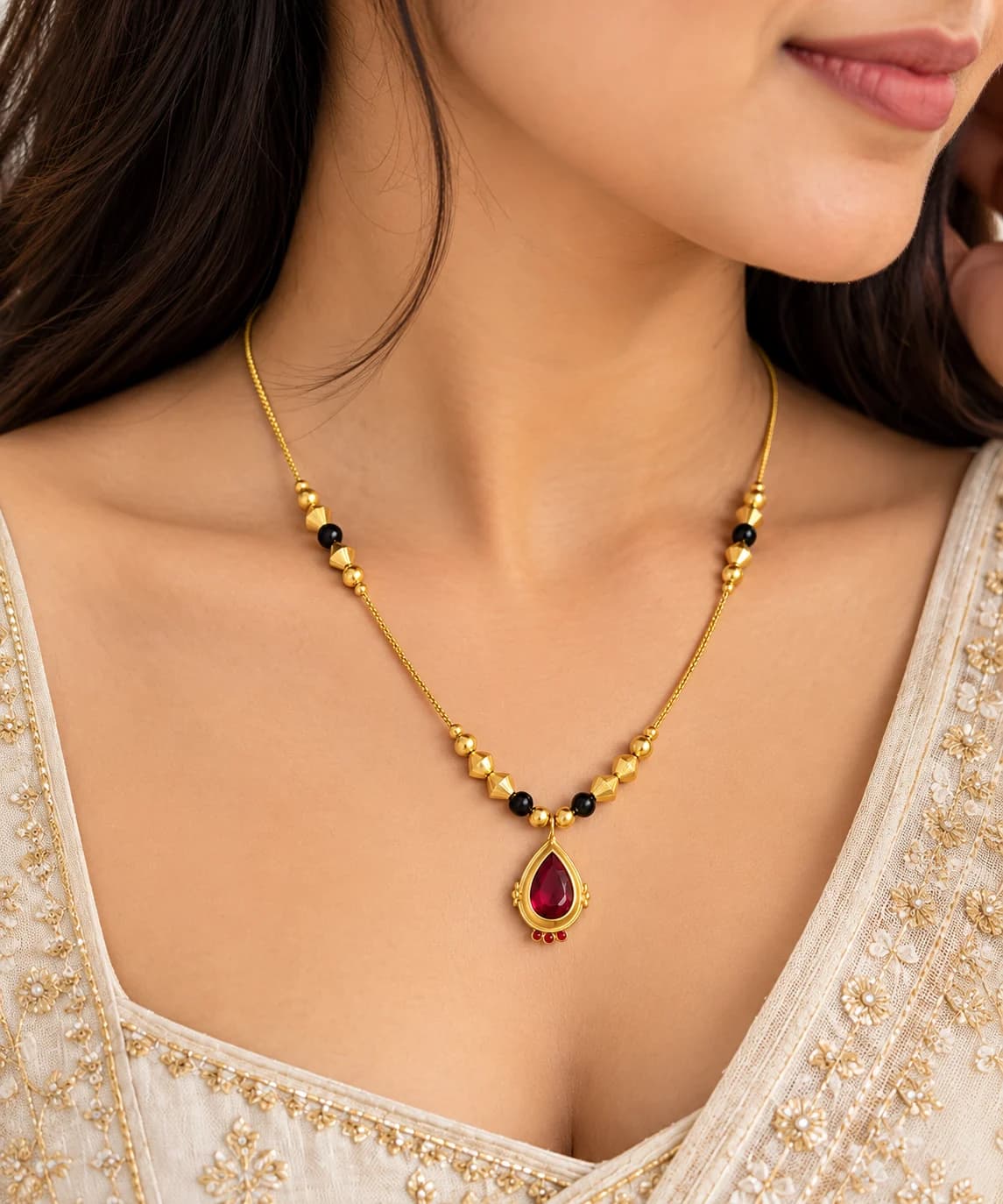Siya red stone mangalsutra worn with an ivory embroidered outfit