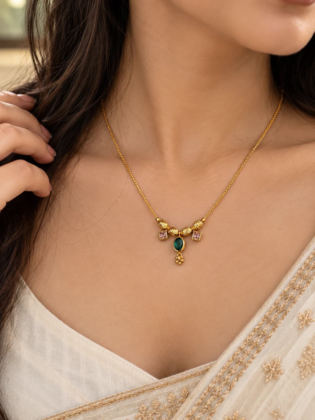 Priya green stone mangalsutra worn with an ivory saree